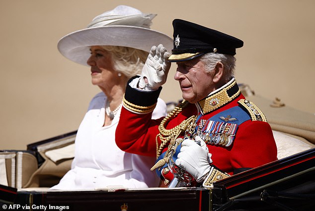 King Charles III salutes next to Britain's Queen Camilla as they arrive to Horse Guards Parade for the King's Birthday Parade