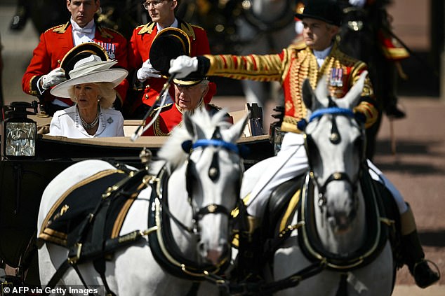 Britain's King Charles III and Britain's Queen Camilla make their way from Buckingham Palace to Horse Guards Parade for the King's Birthday Parade