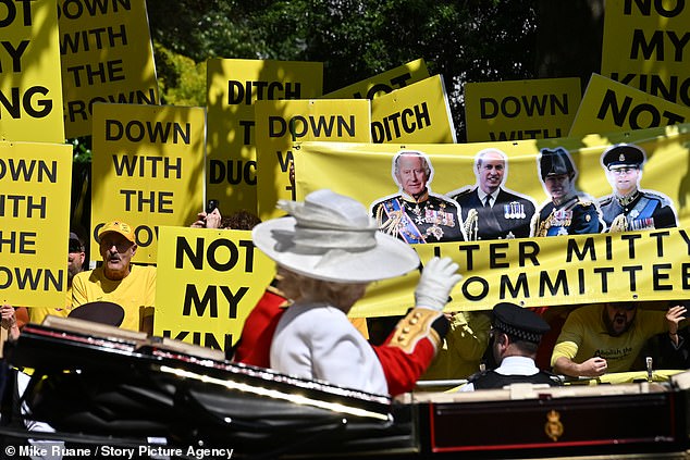 The King waves to protesters against the monarchy who lined a section of the Mall on Saturday