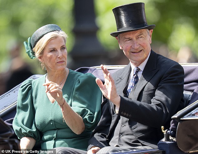Sophie, Duchess of Edinburgh and Timothy Laurence wave during Trooping The Colour 2025