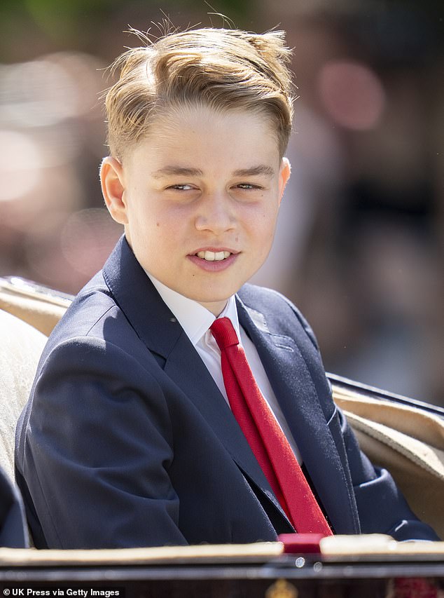 Prince George was dressed in a navy blue suit and red tie for today's event