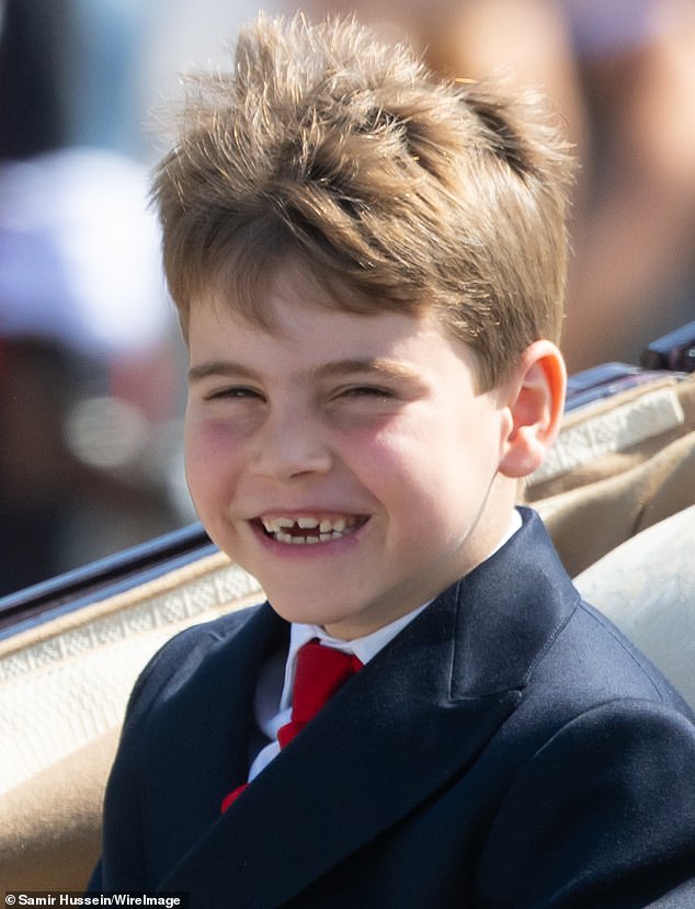 A gust of wind caught Prince Louis off guard, as he beamed out at the crowds with windswept hair