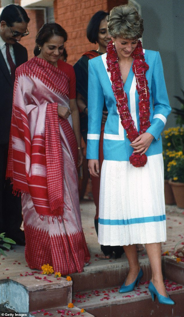 Diana, Princess of Wales, wearing a blue and white suit designed by Catherine Walker and a flower garland round her neck, during a visit to Tamana Special School in New Delhi