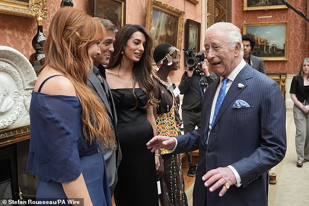 The King donned a pin stripe suit for the event, which took place at Buckingham Palace after the reception