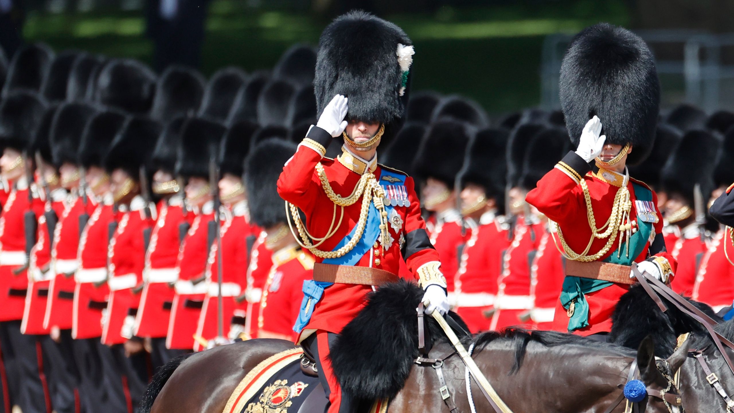 Prince William (L) salutes during Trooping The Colour 2025 on June 14, 2025