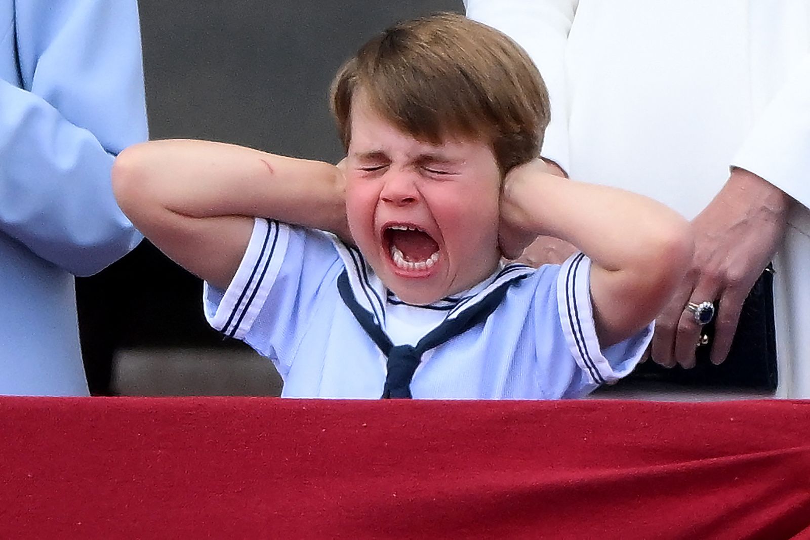 Image may contain Face Head Person Accessories Jewelry Ring Baby Formal Wear Tie Yawning Crying Sad and Angry
