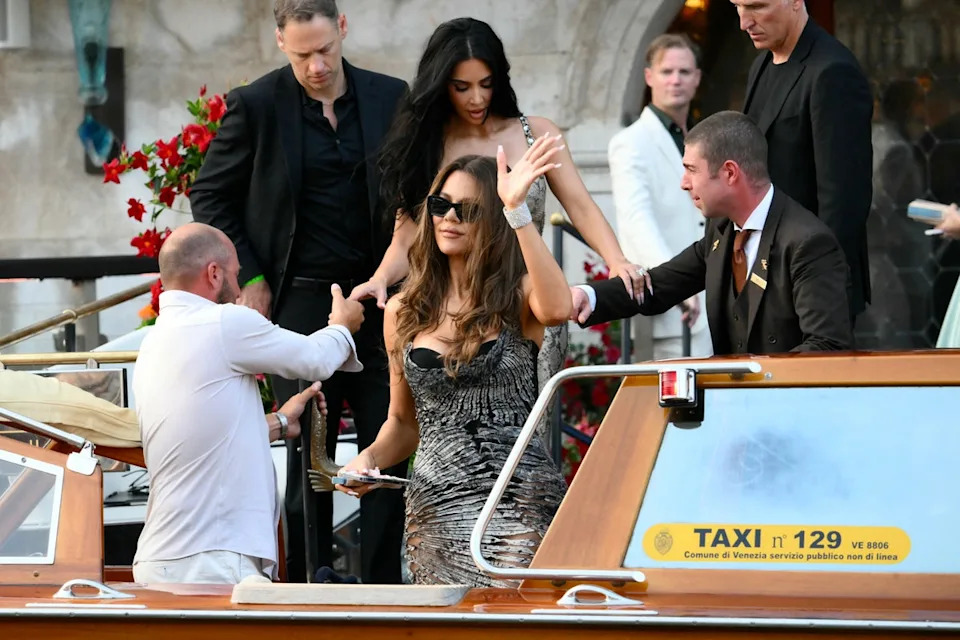 Khloe Kardashian headed to Bezos’s welcome party in a black corset, worn underneath a silver printed dress. The design of the gown was a bit messy, as it looked like it was slightly cut open in various spots (AFP via Getty Images)