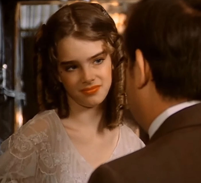 Brooke Shields in a vintage film scene, engaging in conversation, related to Meghan Markle podcast interview controversy. Brooke Shields in a vintage film scene, engaging in conversation, related to Meghan Markle podcast interview controversy.