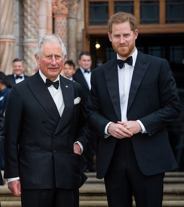 King Charles in a tuxedo poses with his son Prince Harry on the steps of the National History Museum in 2019