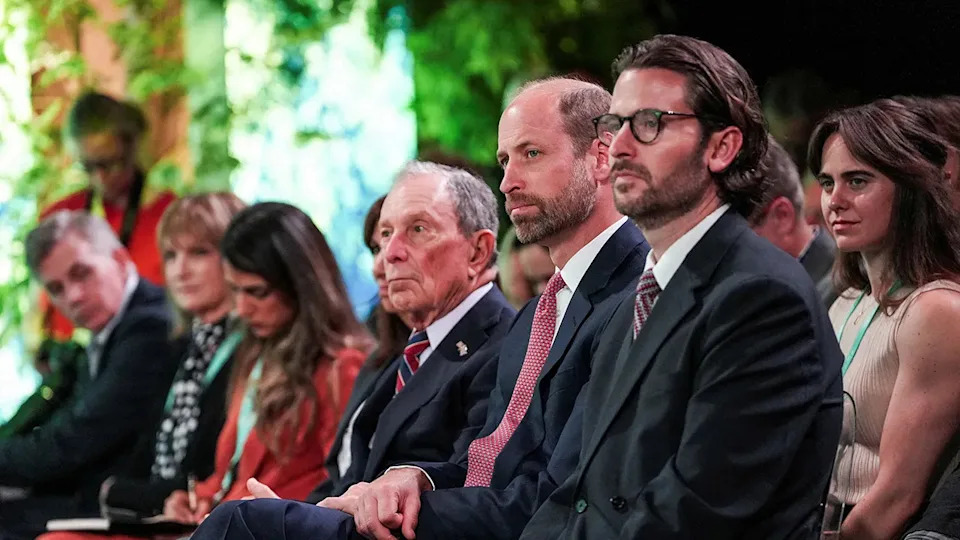Prince William sitting down between Michael Bloomberg and Jason Knauf.