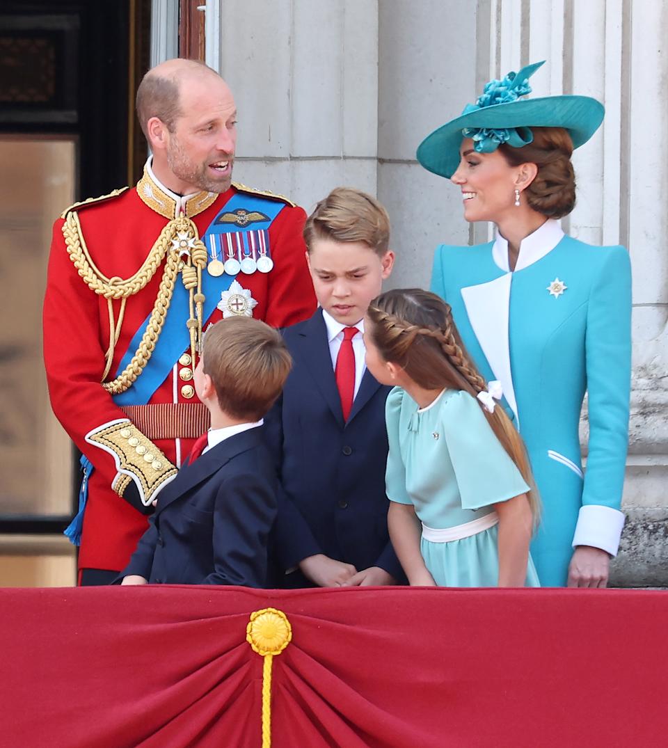 Kate Middleton and Prince William talking on the Buckingham Palace balcony at Trooping the Colour