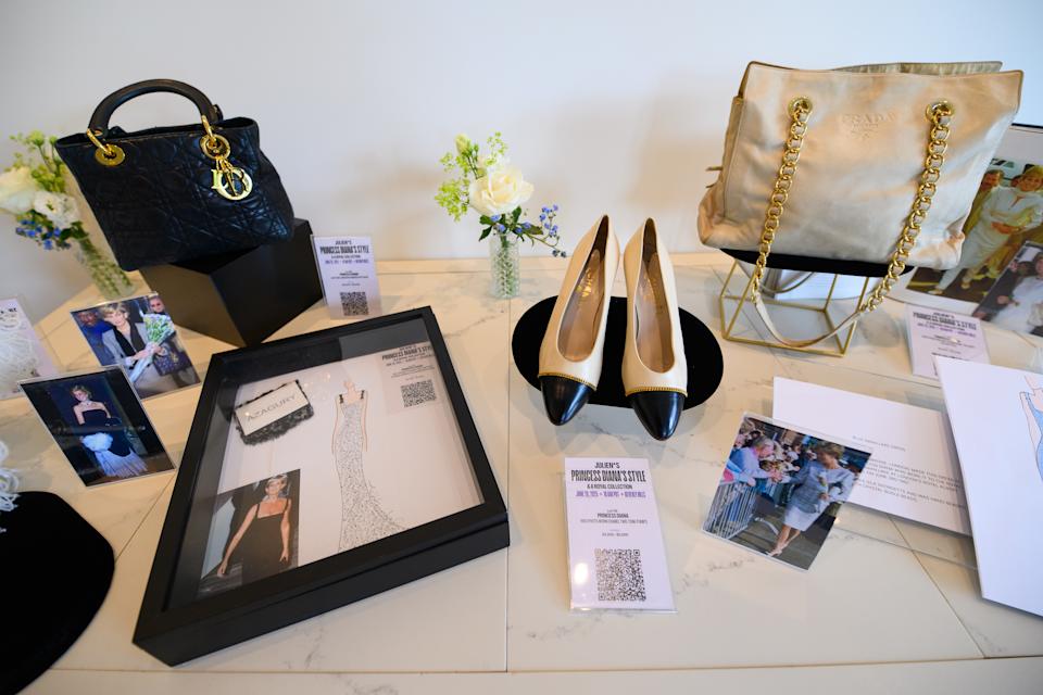 Princess Diana's shoes and purses on a display table for a 2025 fashion auction