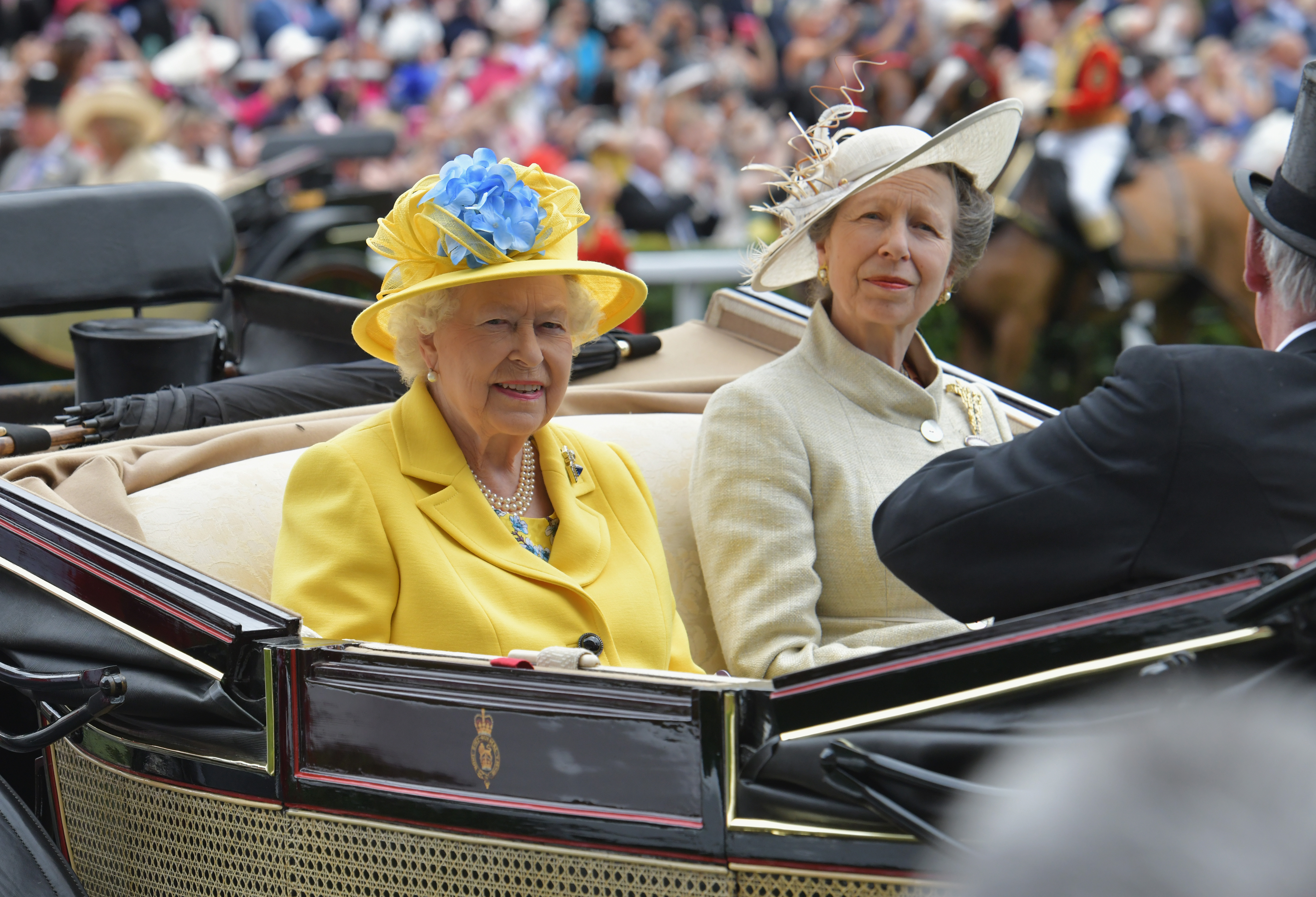 Queen Elizabeth II wears a yellow outfit and Princess Anne wears a light green suit as they arrive at Royal Ascot at Ascot Racecourse on June 19, 2018