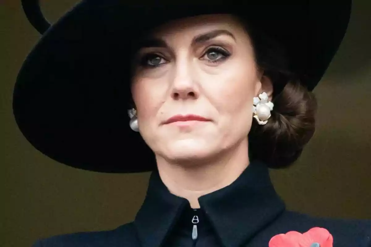 Woman with black hat and pearl earrings.