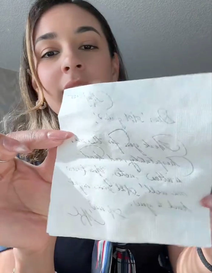 Woman holding a handwritten note, related to Meghan Markle accused of treating her kids like accessories story. Woman holding a handwritten note, related to Meghan Markle accused of treating her kids like accessories story.