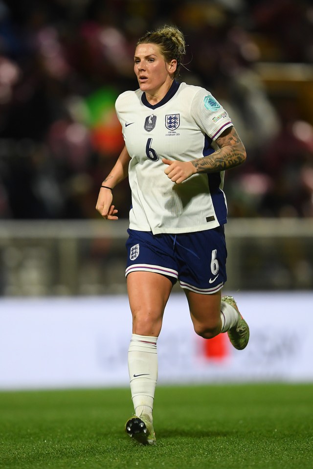 Millie Bright of England's women's national football team running on the pitch.