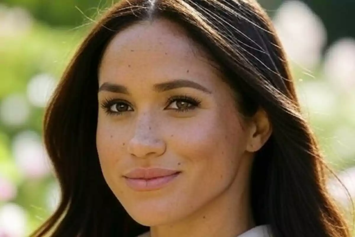 Close-up of Meghan Markle looking at the camera in a sunny outdoor setting. Close-up of Meghan Markle looking at the camera in a sunny outdoor setting.
