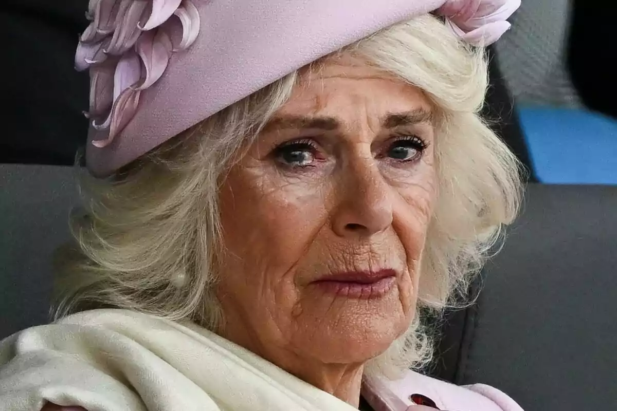 Close-up of Queen Camila crying with a pink headpiece