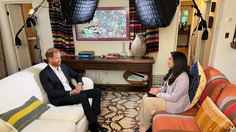Prince Harry being interviewed on a sofa.