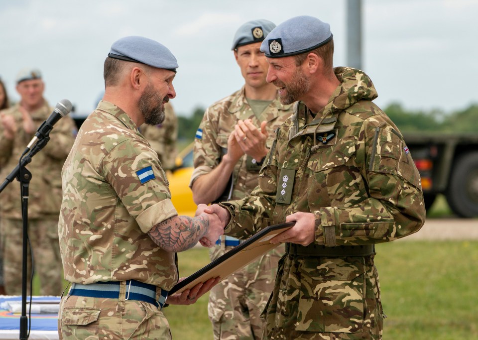 Prince William presenting an award to a soldier.