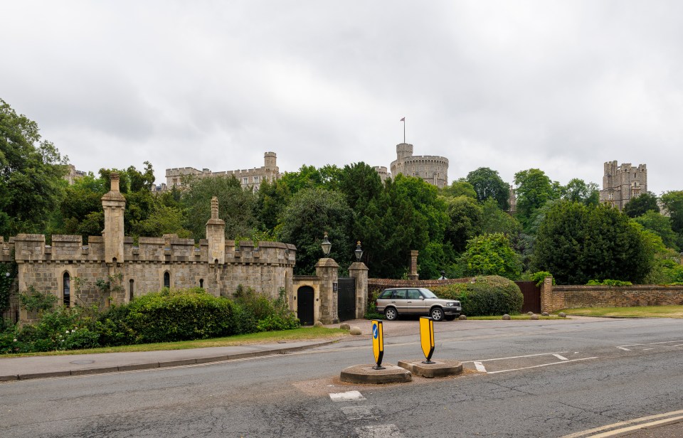 Windsor Castle town gate with a car parked nearby.