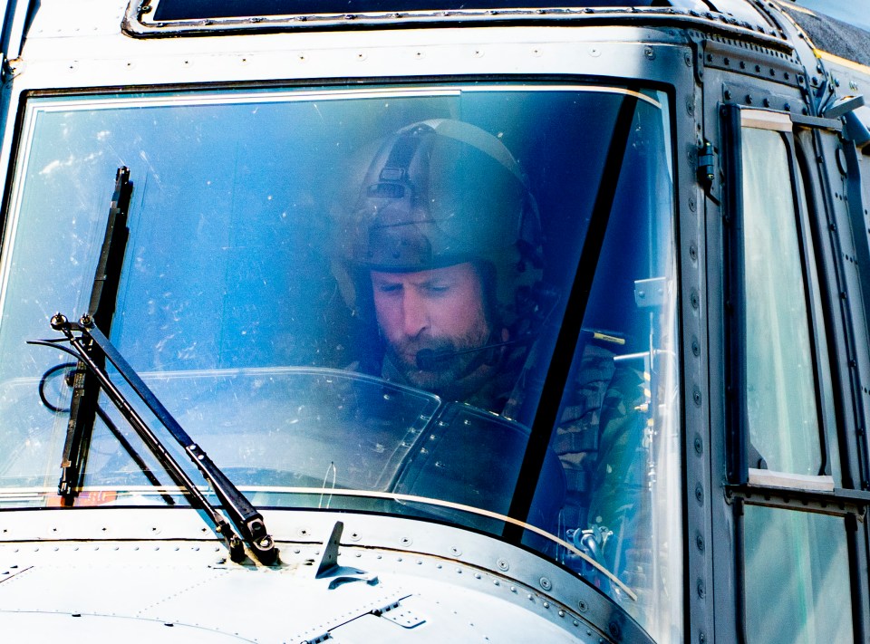 Prince William piloting a helicopter.