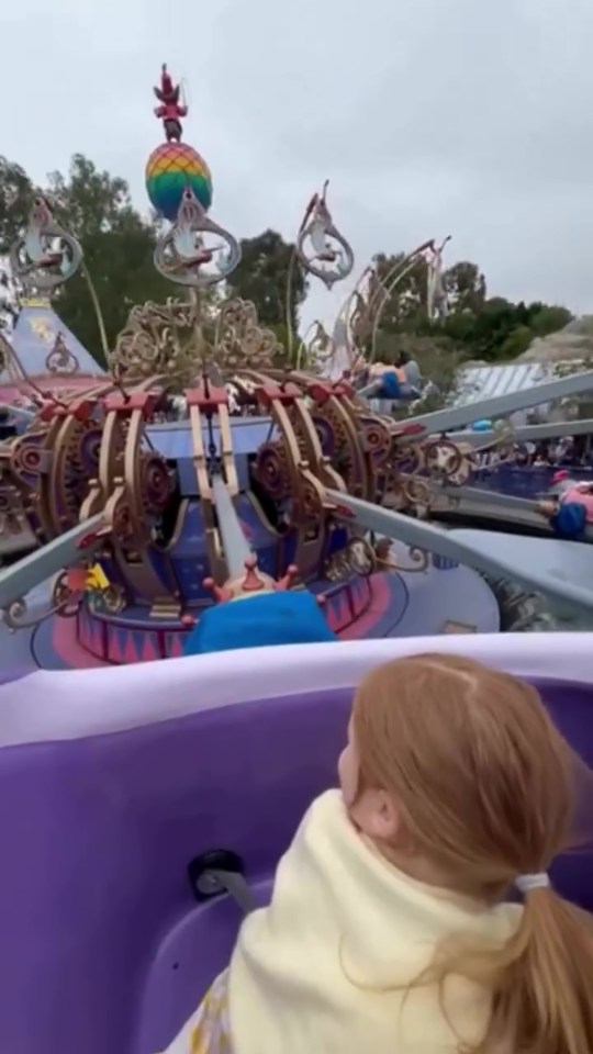 A young girl on a Disneyland ride.