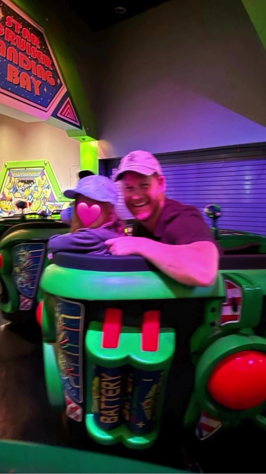 Prince Harry and a child on a ride at Disneyland.
