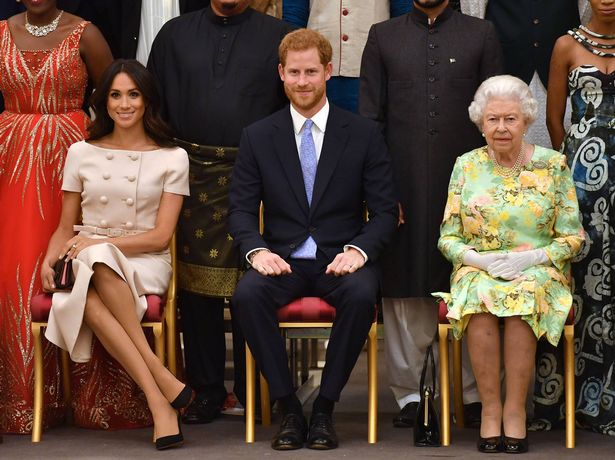 Meghan, Duchess of Sussex, Prince Harry, Duke of Sussex and Queen Elizabeth II at the Queen's Young Leaders Awards Ceremony at Buckingham Palace on June 26, 2018