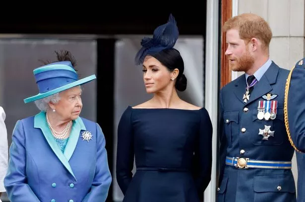 Queen Elizabeth II and Meghan Markle are pictured on July 10, 2018 on the balcony of Buckingham Palace