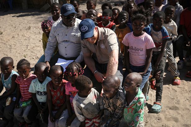 Prince Harry playing with a child at Cuito Cuanavale in Angola