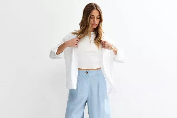 Woman wearing long blue shorts