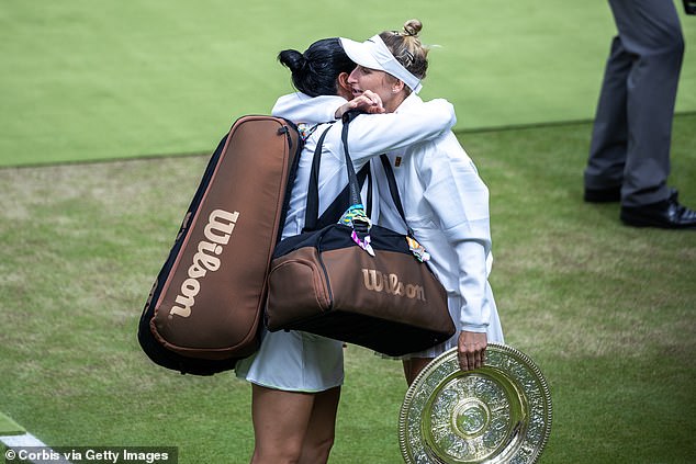 Hugs all round: 15. Vondrousova of the Czech Republic, still holding the winners trophy, hugs a tearful Jabeur of Tunisia as she leaves the court