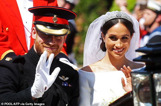 The Duke and Duchess of Sussex during a carriage procession after their wedding ceremony