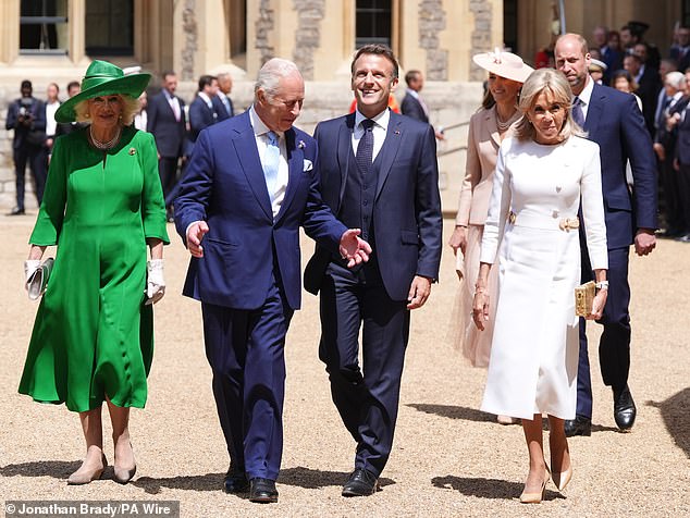 Camilla, Charles and the Macrons pictured beaming at the ceremonial welcome at Windsor Castle today