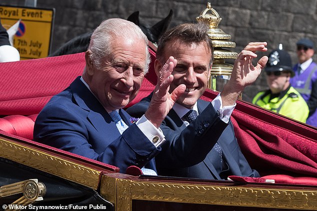 King Charles III and Emmanuel Macron pictured travelling in a 1902 State Landau through Windsor today