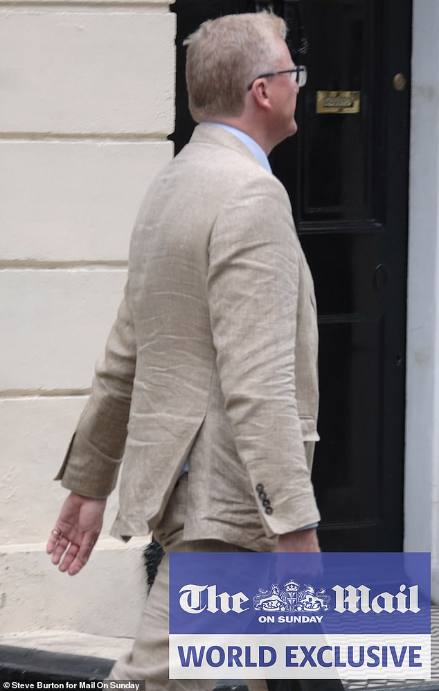 Tobyn Andreae arrives for the secret meeting - turning up minutes after Ms Maines with a gift from Berry Bros & Rudd