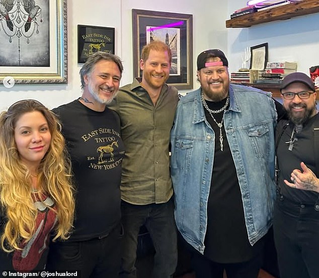 During his visit, Harry posed for a photograph with Josh Lord (pictured second left), Jelly Roll (second right) and East Side Ink staff