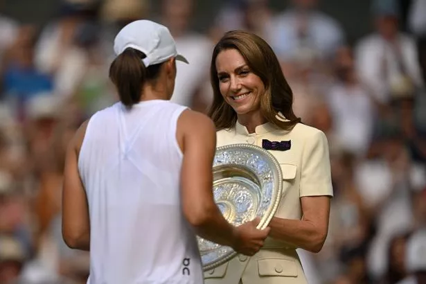 LONDON, ENGLAND - JULY 12: Catherine, Princess of Wales, presents Iga Swiatek of Poland with the Ladies’ Singles Trophy following the Ladies' Singles Final against Amanda Anisimova of United States on day thirteen of The Championships Wimbledon 2025 at All England Lawn Tennis and Croquet Club on July 12, 2025 in London, England. (Photo by Visionhaus via Getty Images)