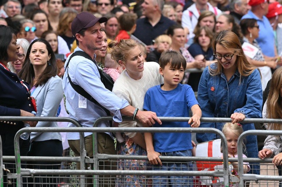 Princess Beatrice, her husband, and their children watching a parade.