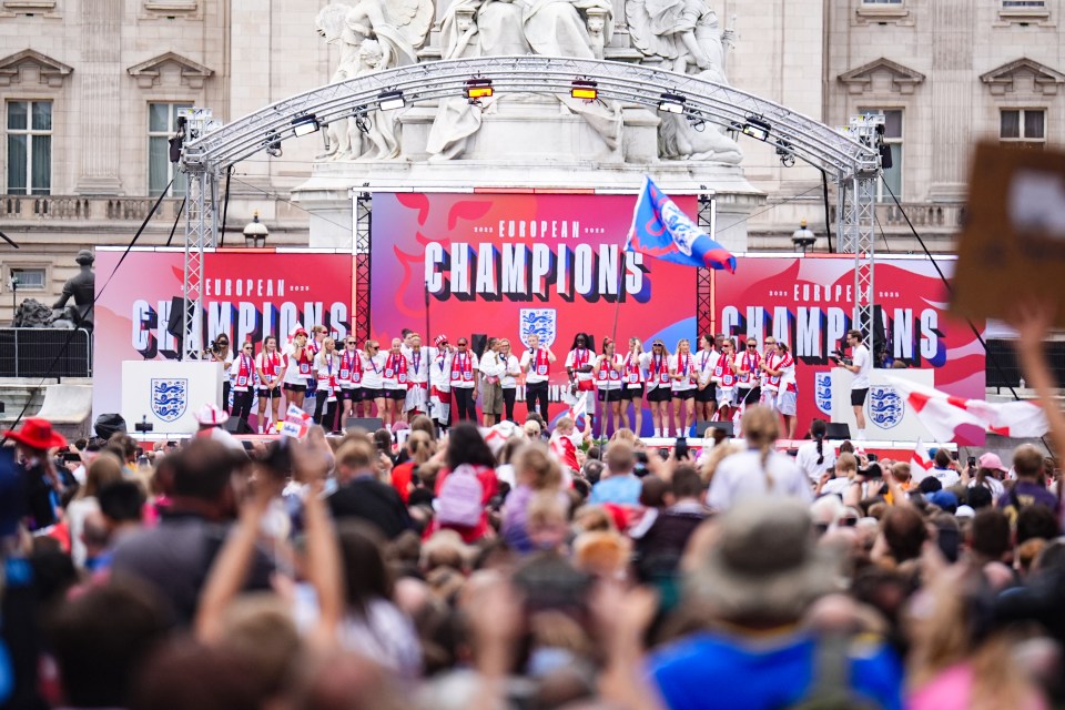 Large crowd watching a parade in London.