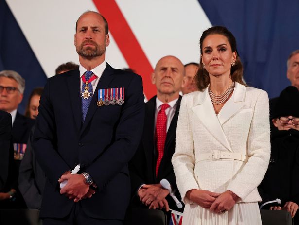 William and Kate stand to listen to the King's speech 