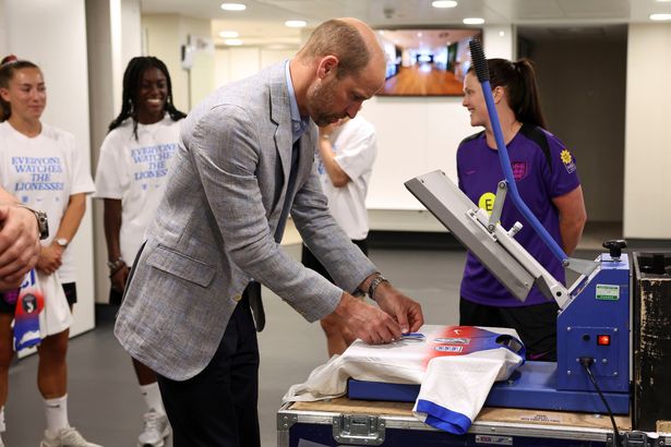 William helps print the name and number on the short of Aggie Beever-Jones