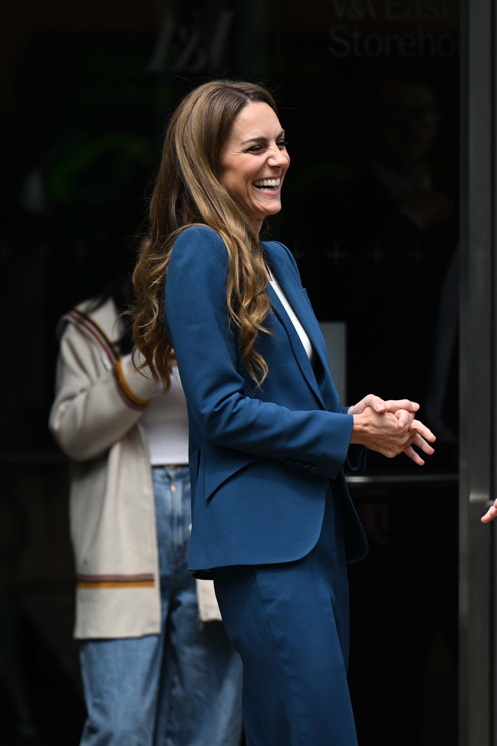 Image may contain Face Happy Head Person Smile Dimples Clothing Formal Wear Suit Adult Blazer Coat and Jacket