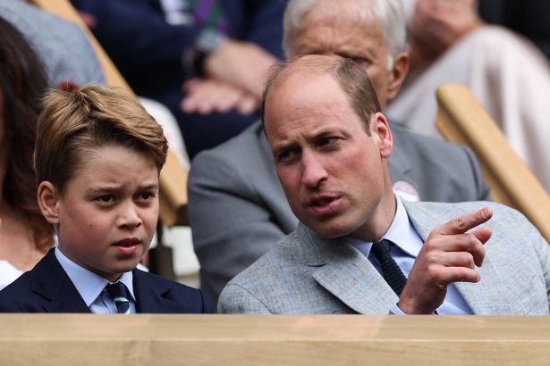 Britain's William, Prince of Wales (R) talks to his son George at the Centre Court' Royal Box 
