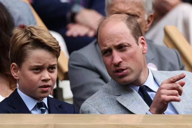 Britain's William, Prince of Wales (R) talks to his son George at the Centre Court' Royal Box 