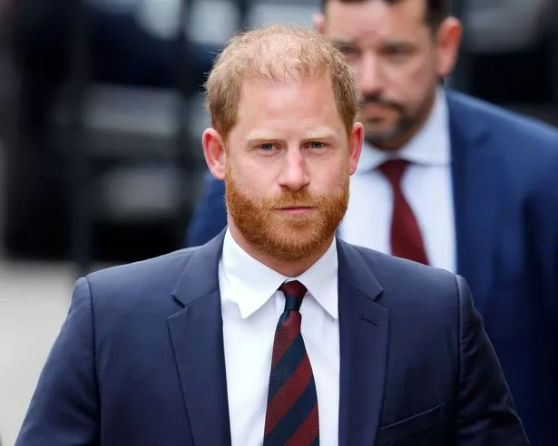 Photo of Prince Harry, dressed in a dark navy suit, attending a court hearing in London
