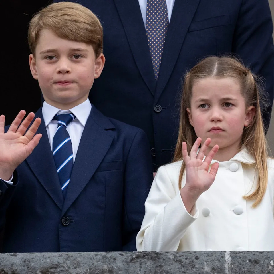  Prince George wears a navy suit with a striped tie, Princess Charlotte wears a white coat, and Prince Louis looks bored. 
