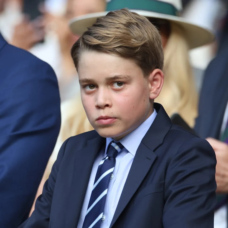  Prince George wears a suit and tie to Wimbledon on July 13 with father Prince William and sister Princess Charlotte. 