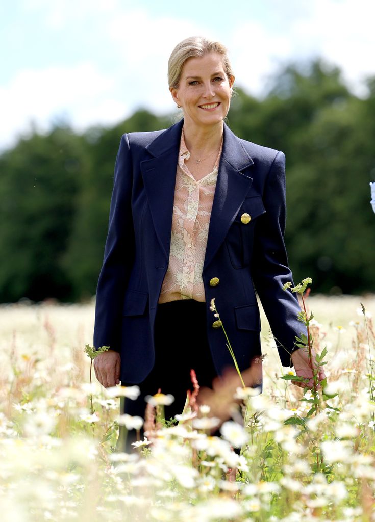 Sophie, Duchess of Edinburgh walking in meadow smiling